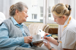 caregiver checking a senior woman